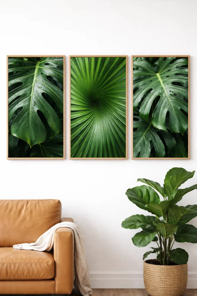 Elegant living room wall decor ideas featuring a triptych of macro monstera leaf photography in light oak wood frames.